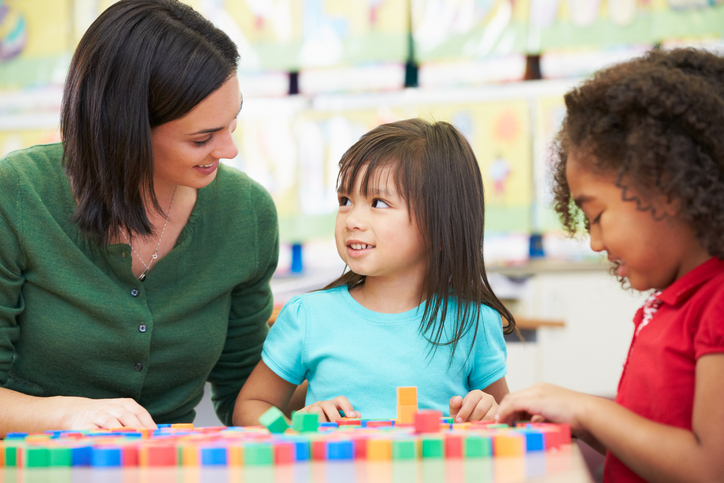 Therapist working with a student using colorful blocks